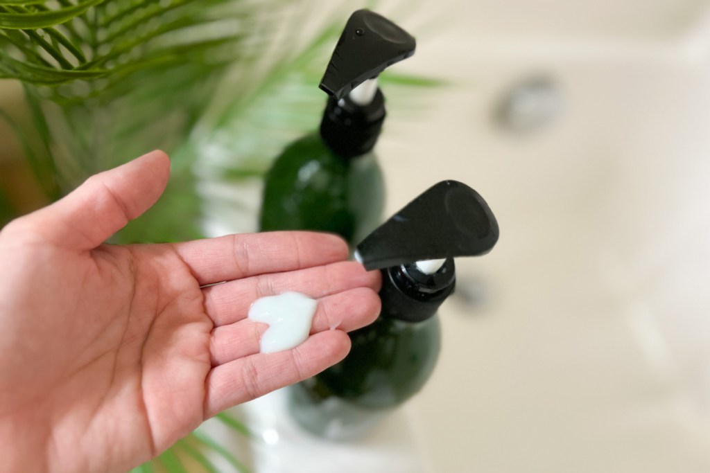 hand pumping shampoo bottle