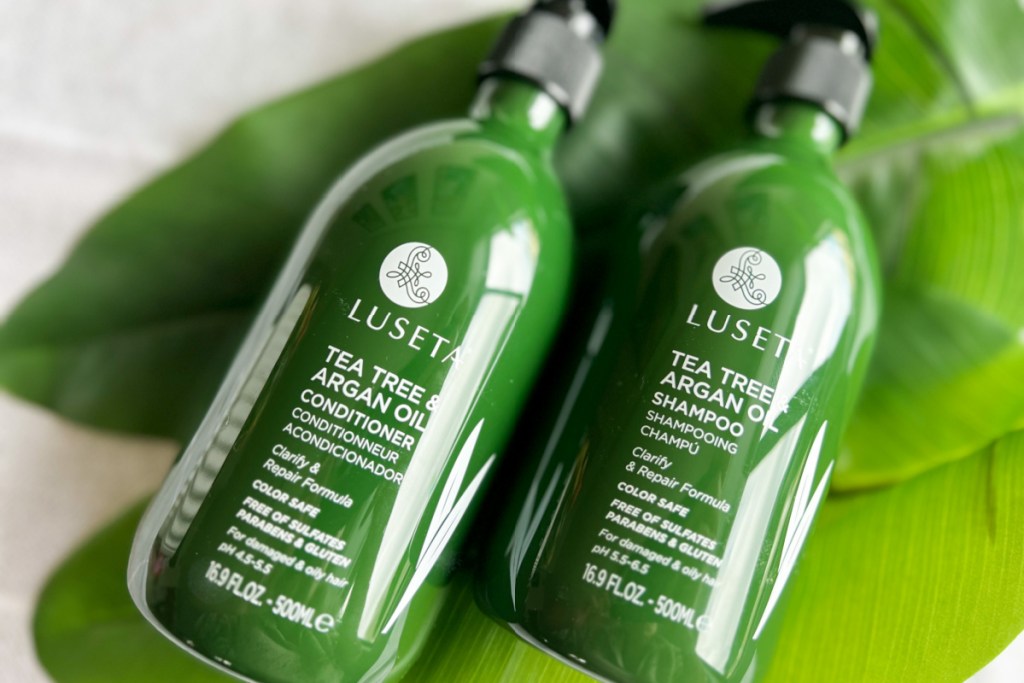green shampoo and conditioner bottles on leaf