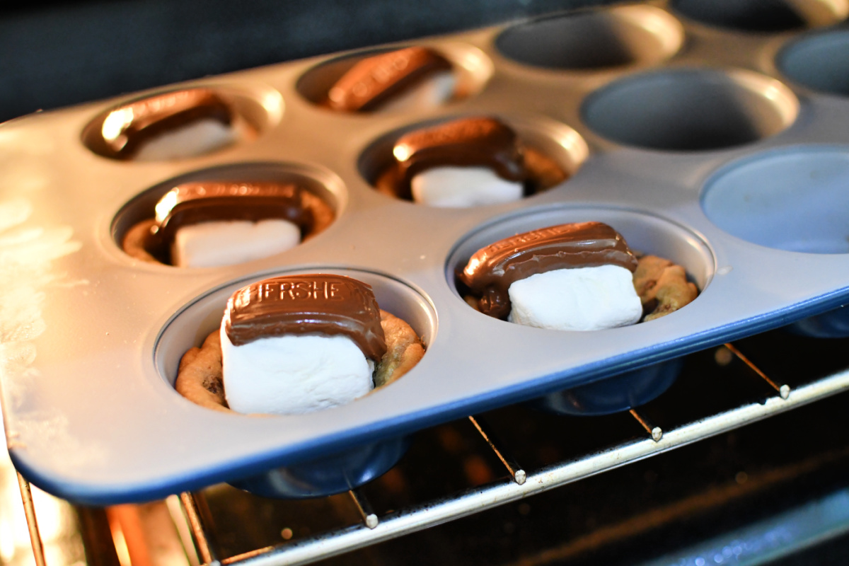 Baking smores cookie cups using marshmallow and chocolate. 