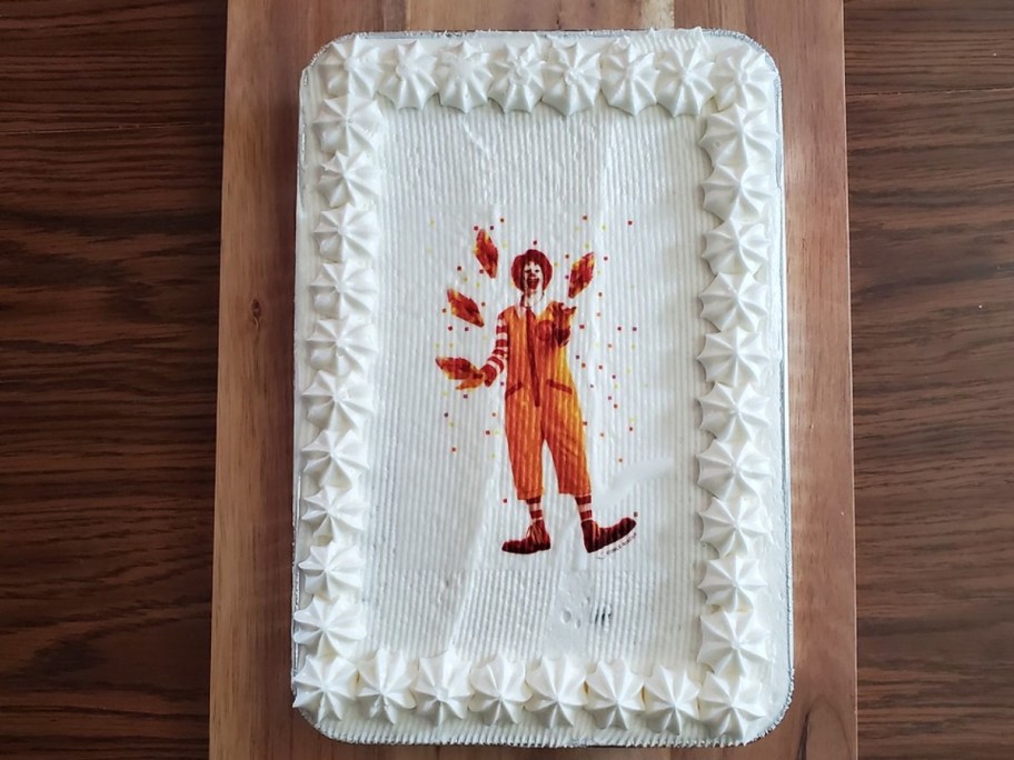 white sheet cake decorated with an image of Ronald McDonald