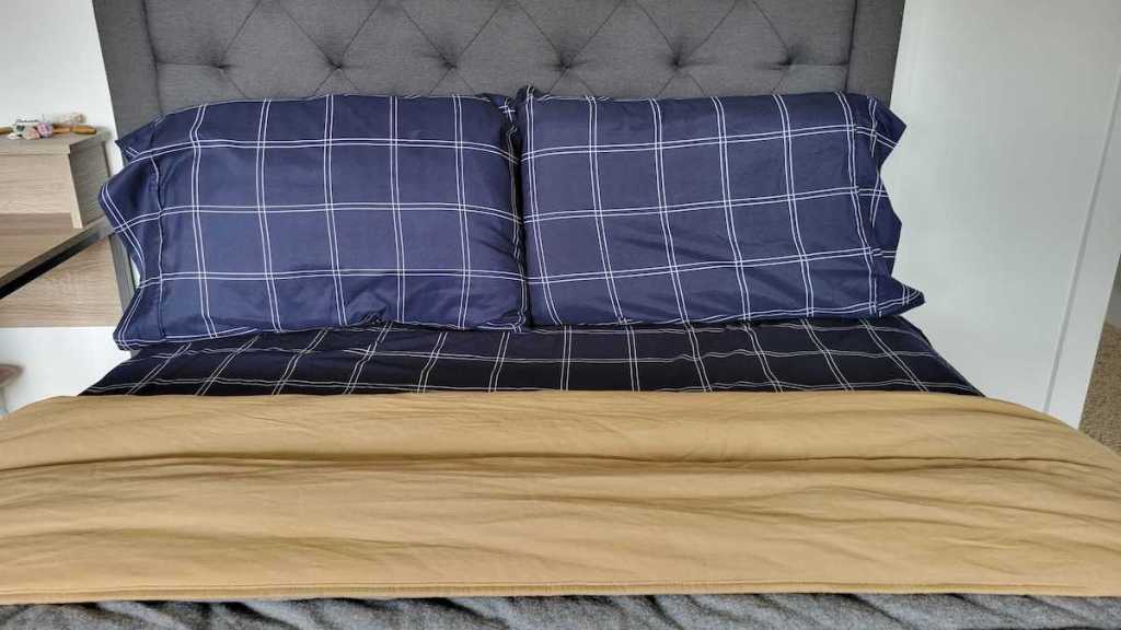 bed with navy blue plaid sheets 