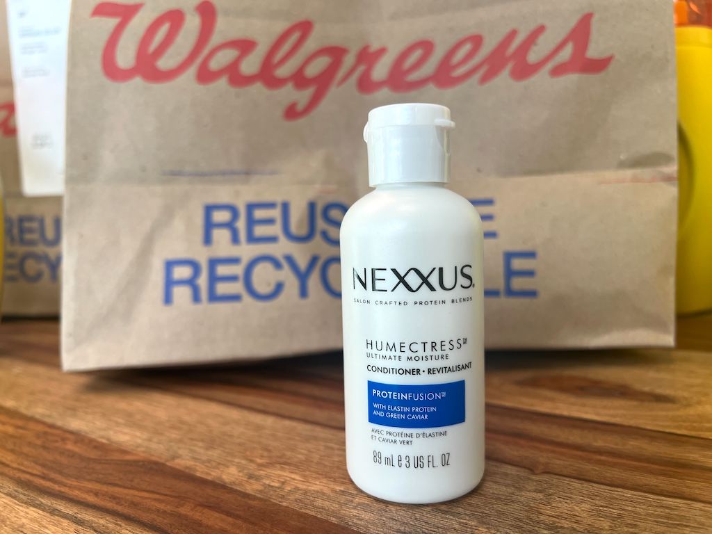 Nexxus travel size conditioner bottle in front of Walgreens bag 