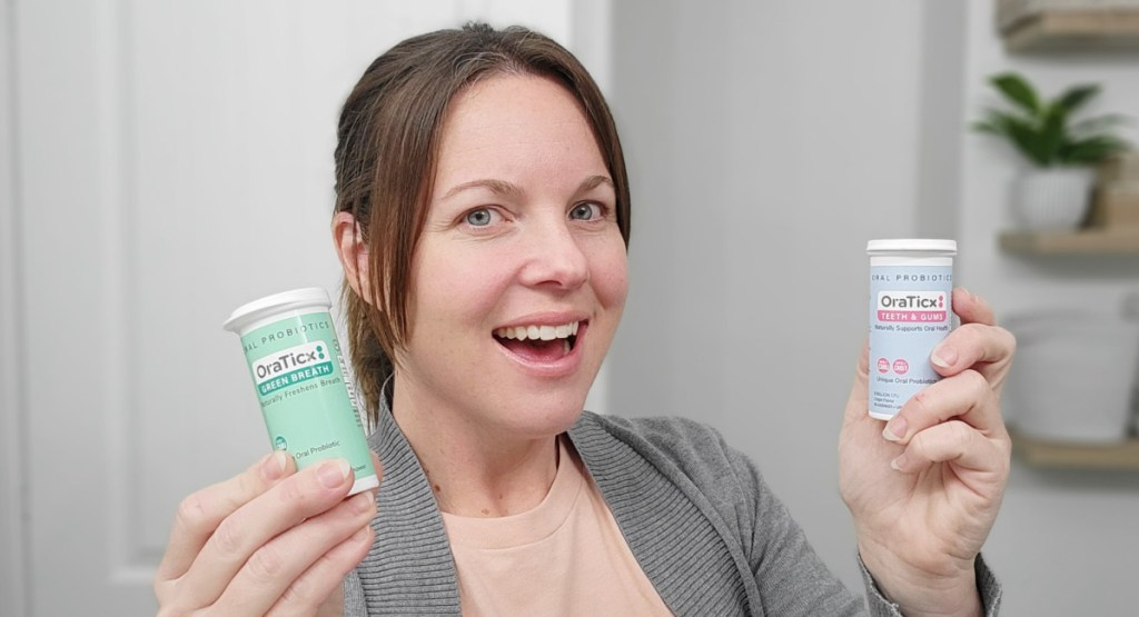 woman holding two tubes of oral lozanges