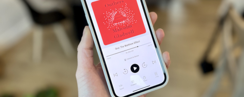hand holding a phone with audible book on screen