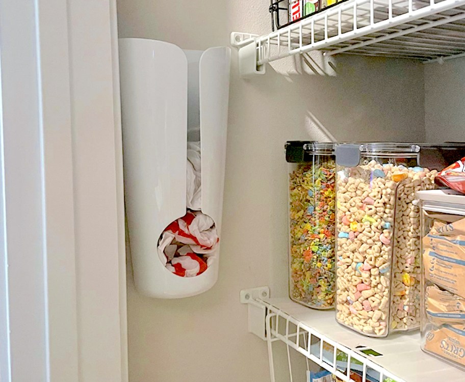 white plastic bag holder on wall which is one of our best pantry organization ideas