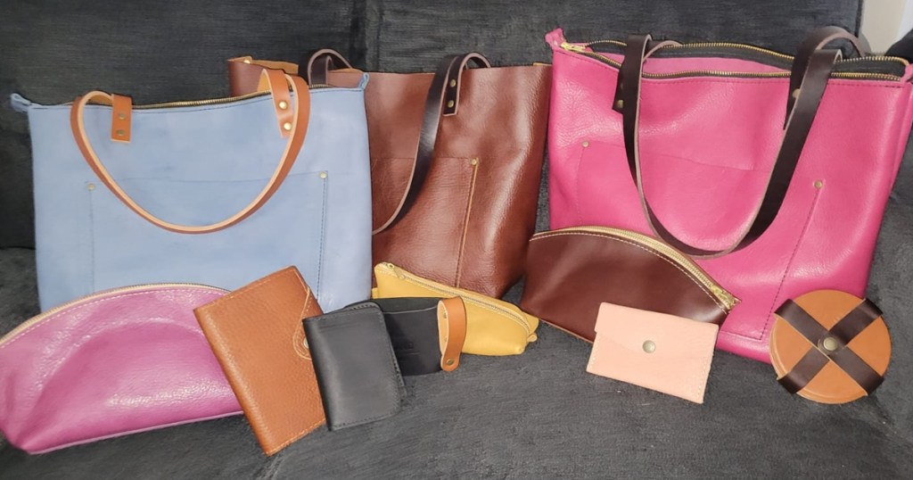 assortment of leather purses and small bags on couch