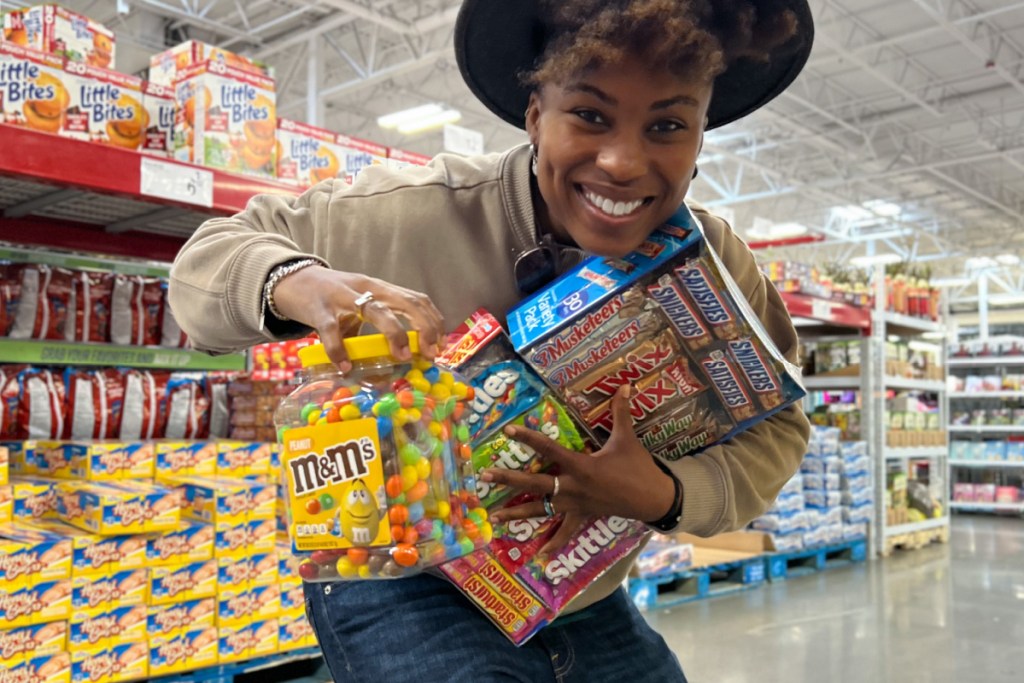 woman holding bulk packs of candy