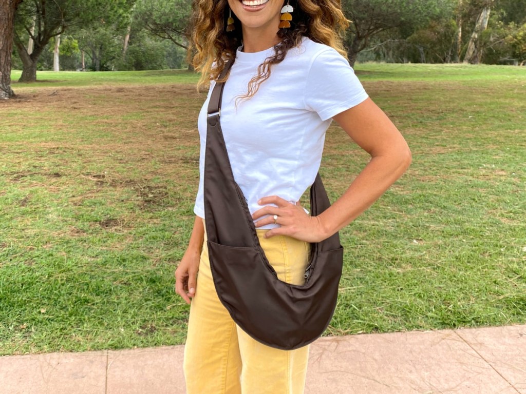 woman wearing brown crossbody sling bag