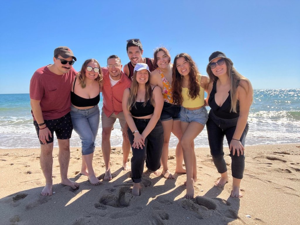group of friends on sandy beach in mexico