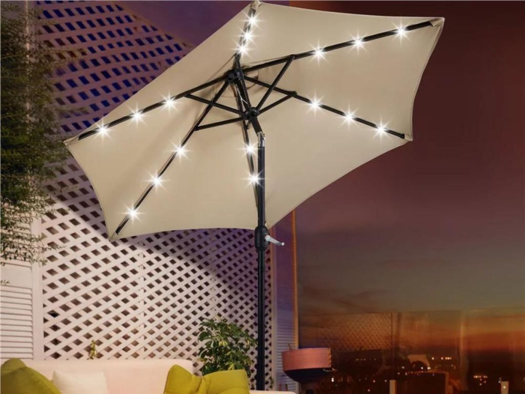 tan umbrella with led lights outdoors at night