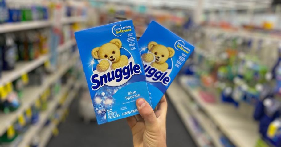 hand holding 2 Snuggle Fabric Softener sheets in store