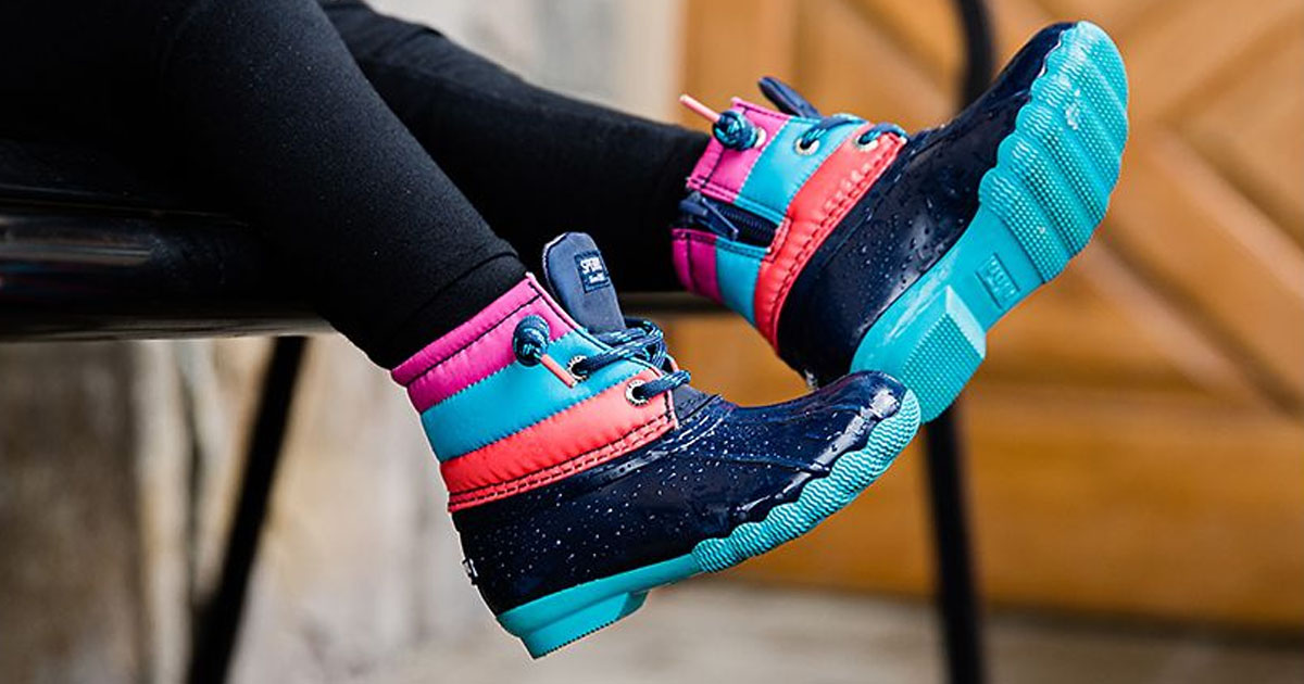 blue, pink, and peach boots on kids feet