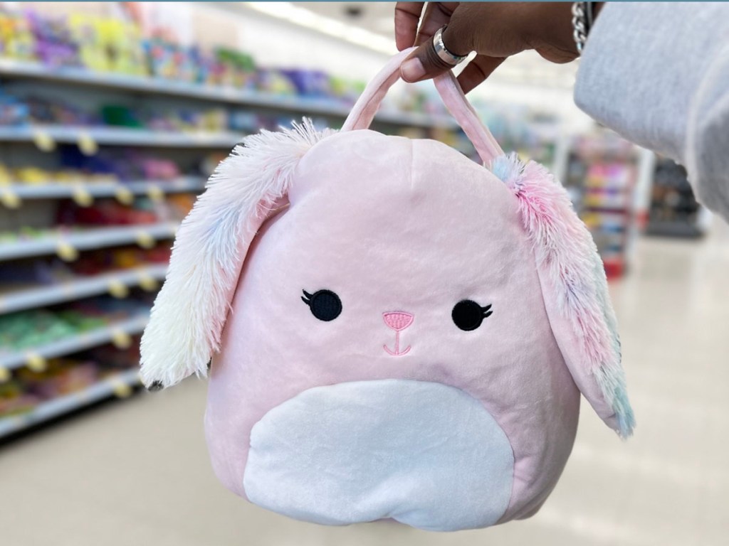 hand holding pink easter bunny squishmallow basket