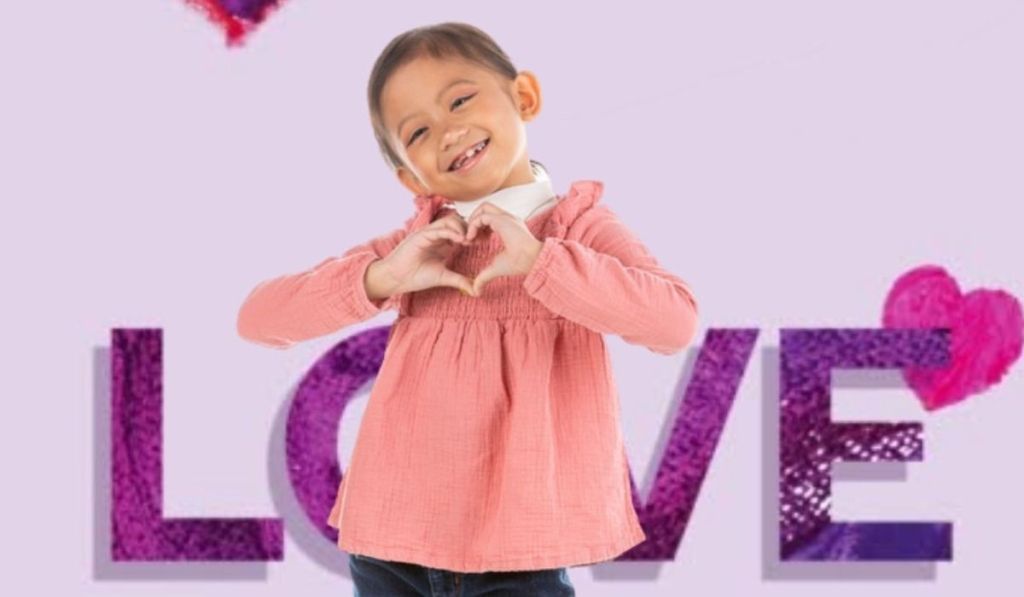 girl making heart symbol with her hands