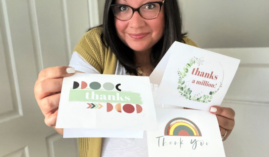 woman holding free printable thank you cards using HP ink
