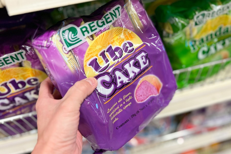 hand grabbing ube cake off shelf