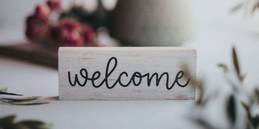 black and white welcome sign on table