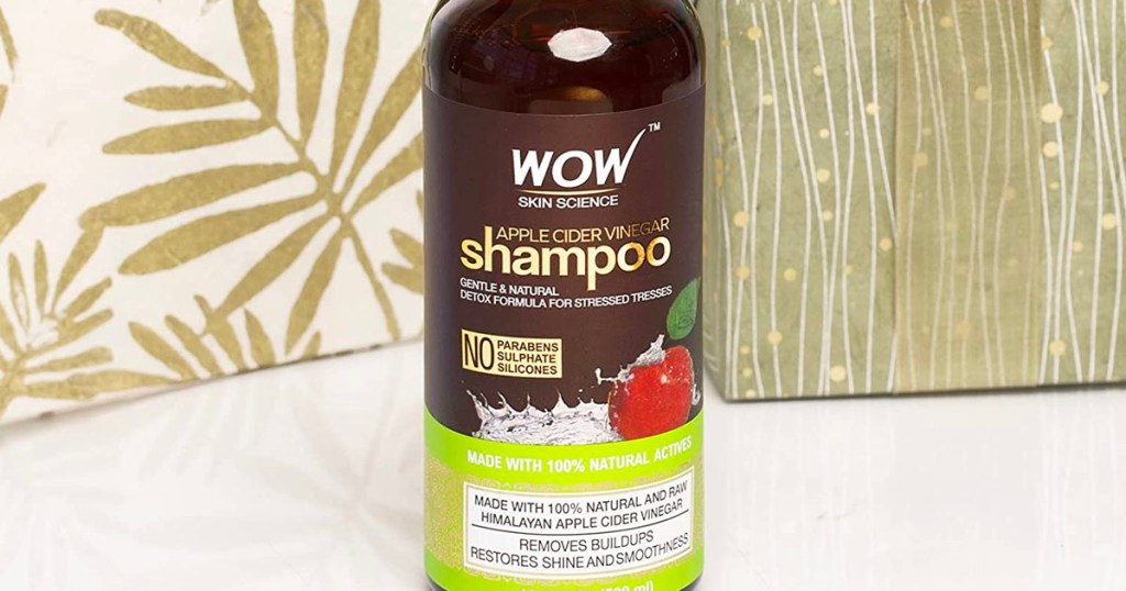 WOW skin science apple cider shampoo on shelf with boxes wrapped in leaf wrapping paper