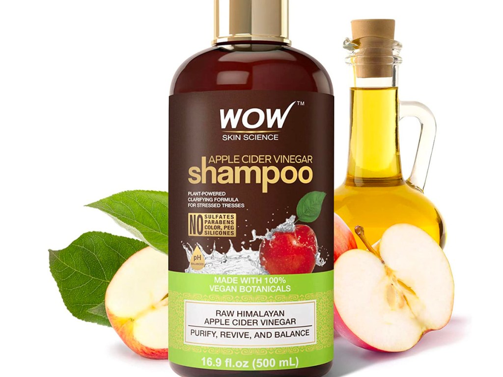 wow science shampoo with apples cut in half and apple cider vingar in a bottle behind it