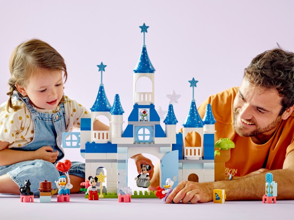 man and child building LEGO Duplo Disney castle
