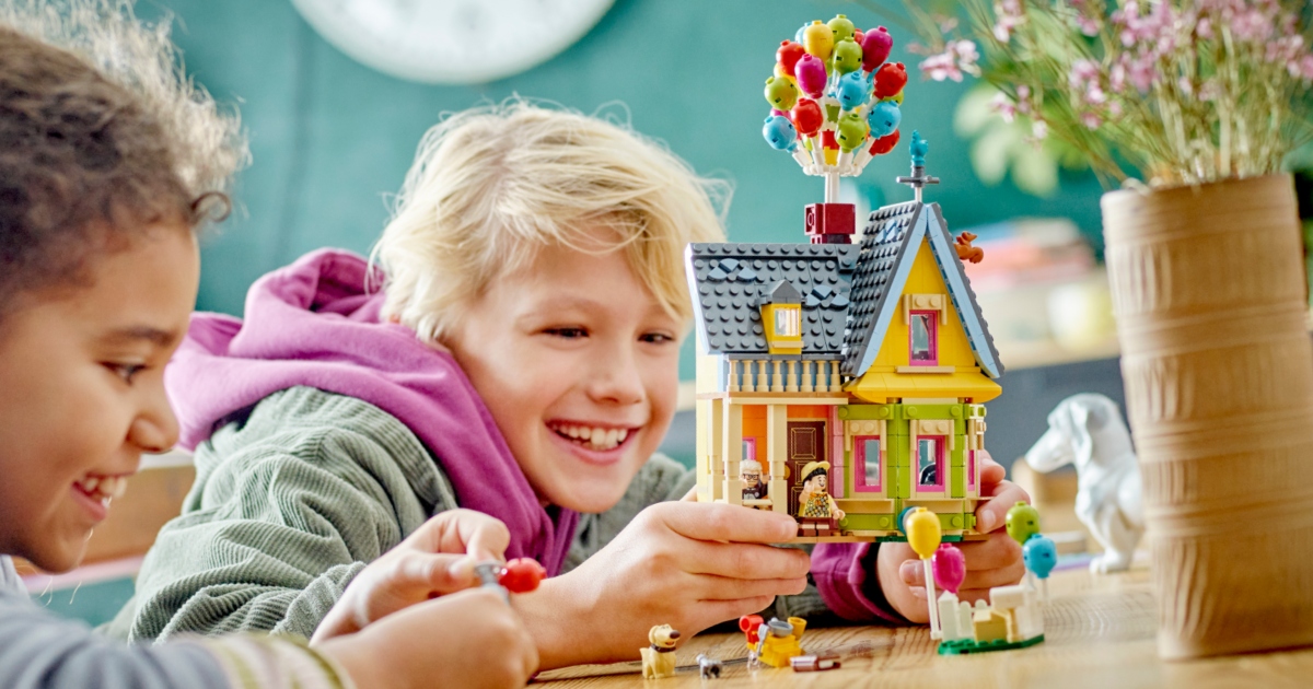 Boy holding LEGO set based on the house from the Disney movie 'Up'