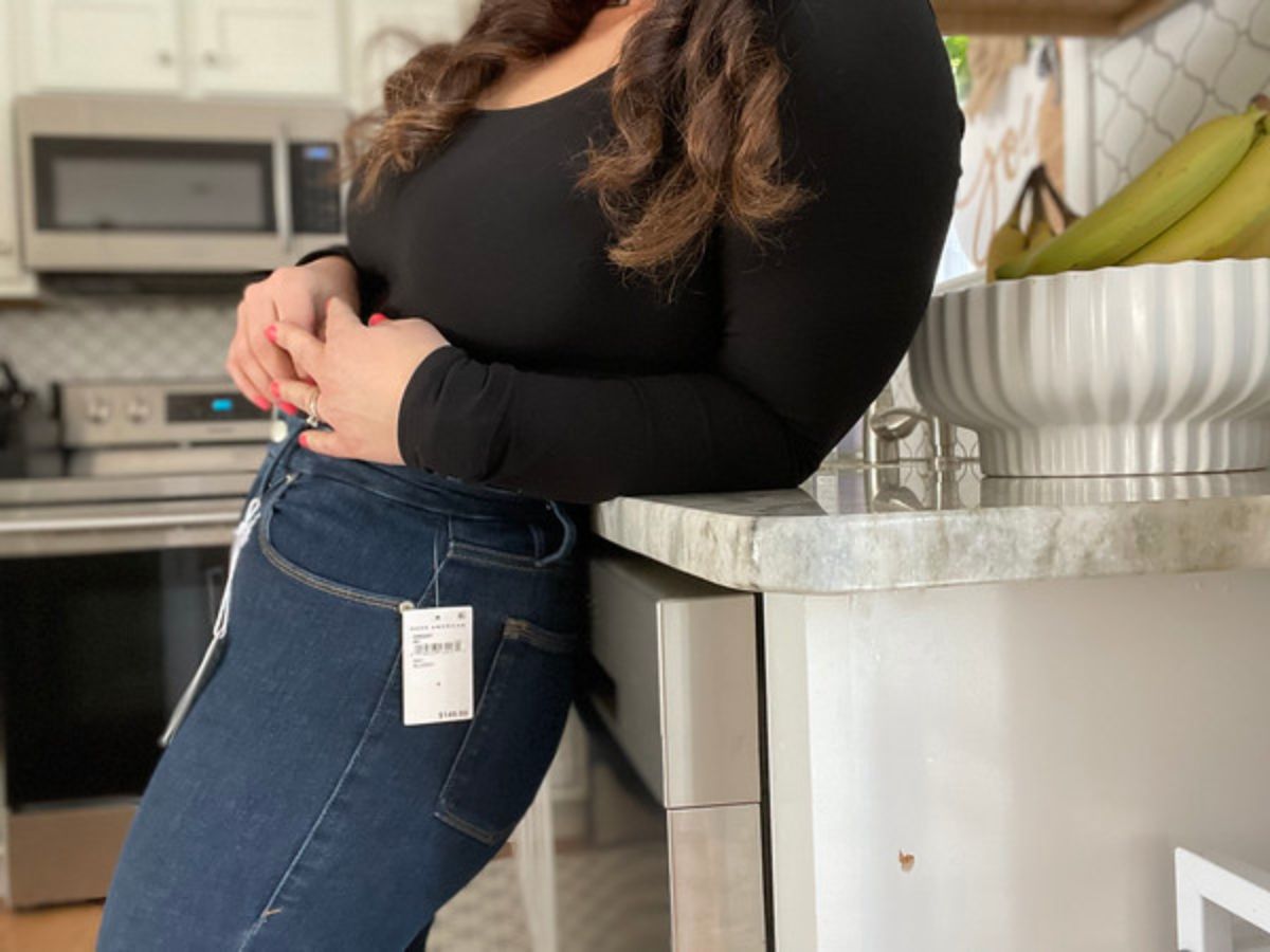 A woman wearing good american jeans in her kitchen