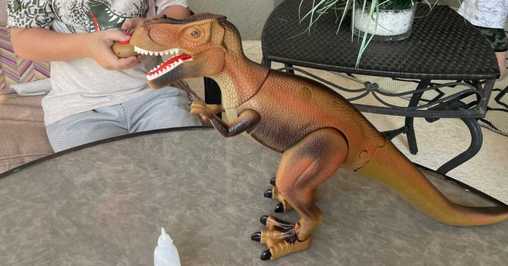 Boy playing with Advanced Play Dinosaur Trex Toy using the remote control