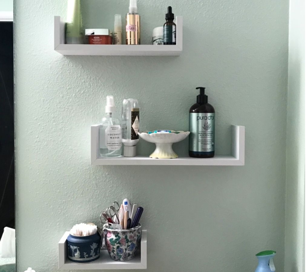 Amada Homefurnishings 3-piece Floating Shelves Set holding toiletries in bathroom above the toilet