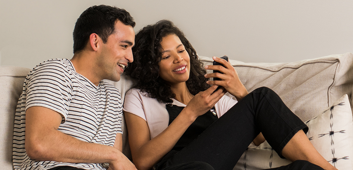 A couple shopping on their phones using Amazon Household, one of the top Amazon Prime membership benefits and perks