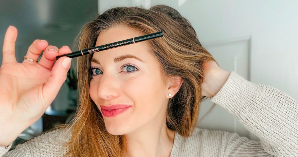 woman using Anastasia Beverly Hills Brow Wiz Ultra-Slim Precision Brow Pencil