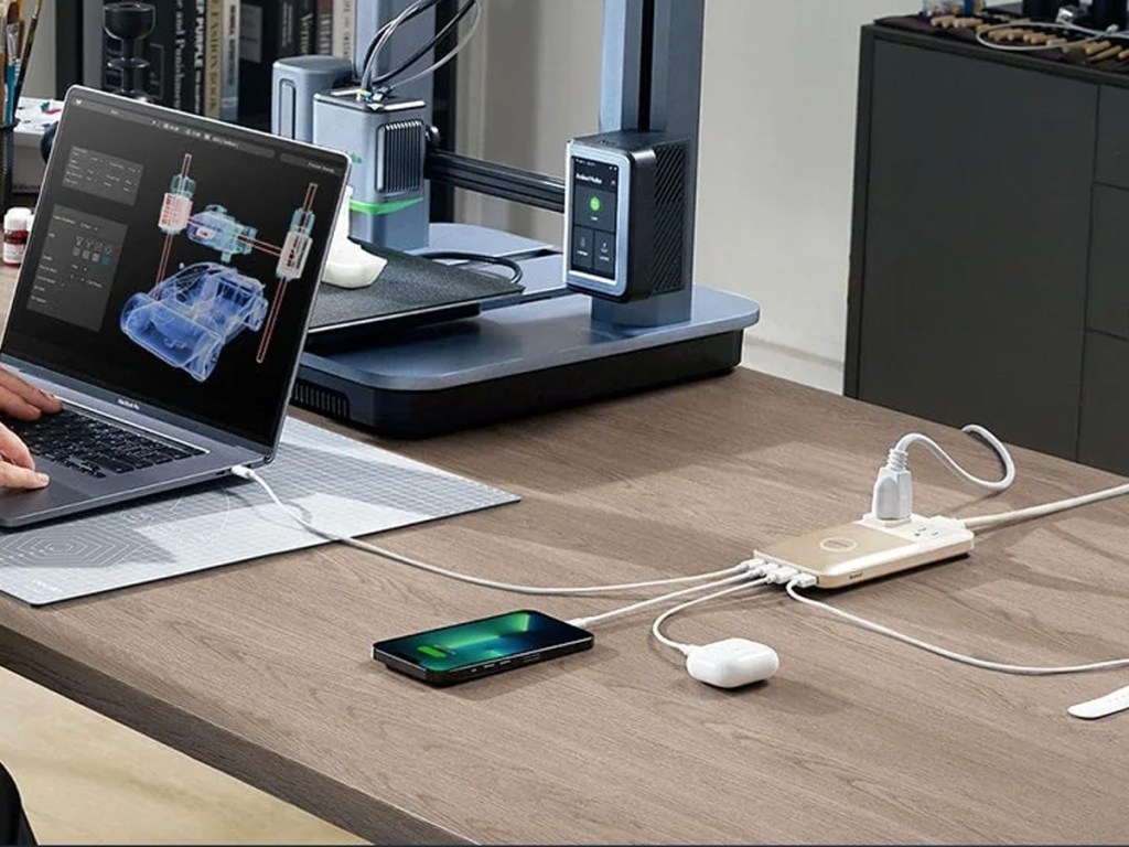 laptop, phone, and airpods plugged into charging station