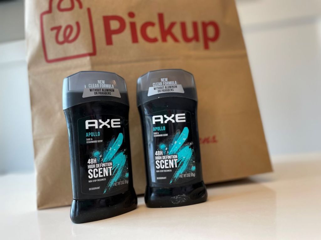 Two Axe deodorants by a bag