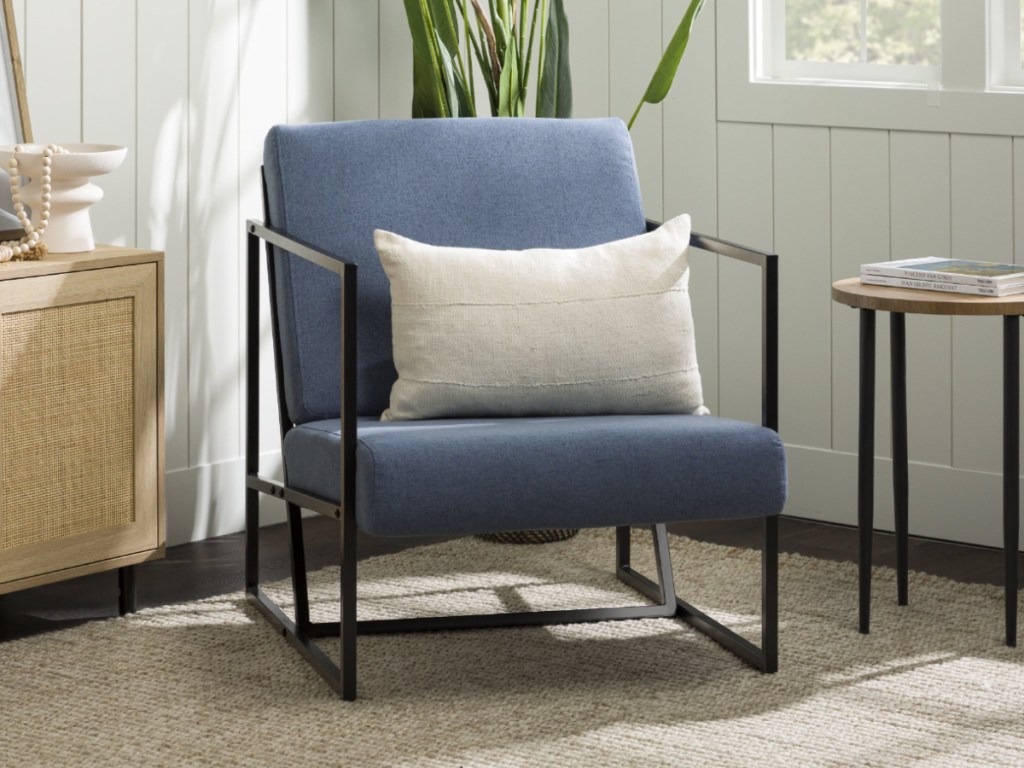 blue cushioned chair with black metal frame in living room