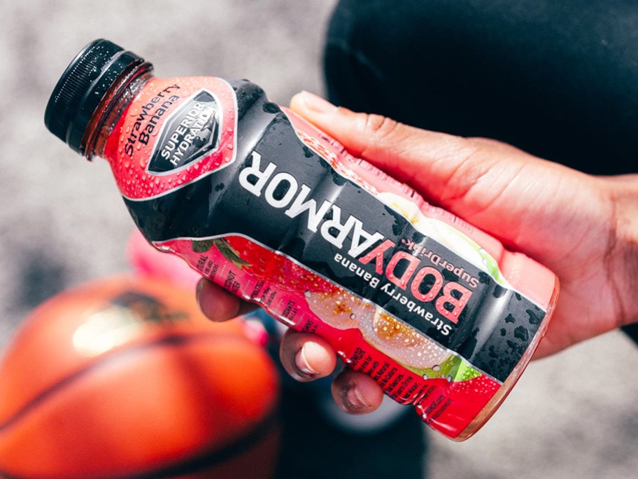 hand holding a bottle of strawberry banana Body Armour