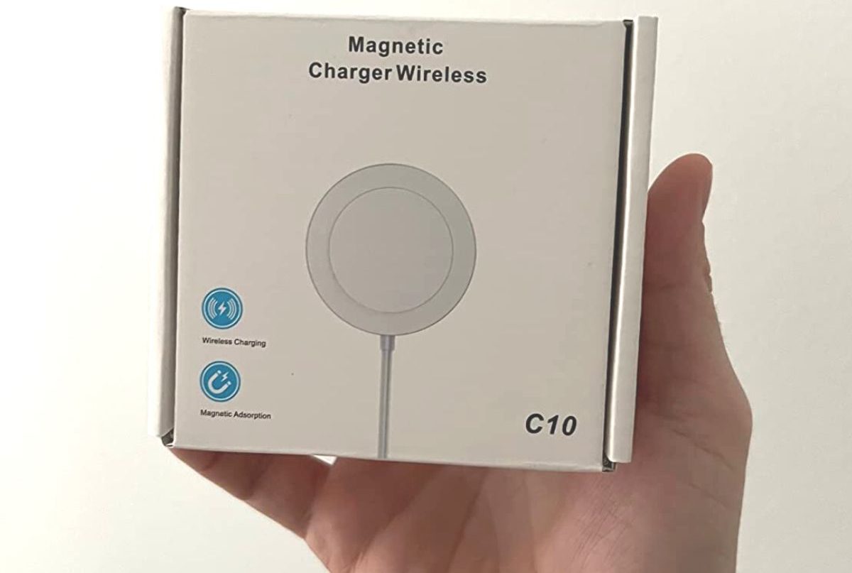 Hand holding up a box for a wireless phone charger