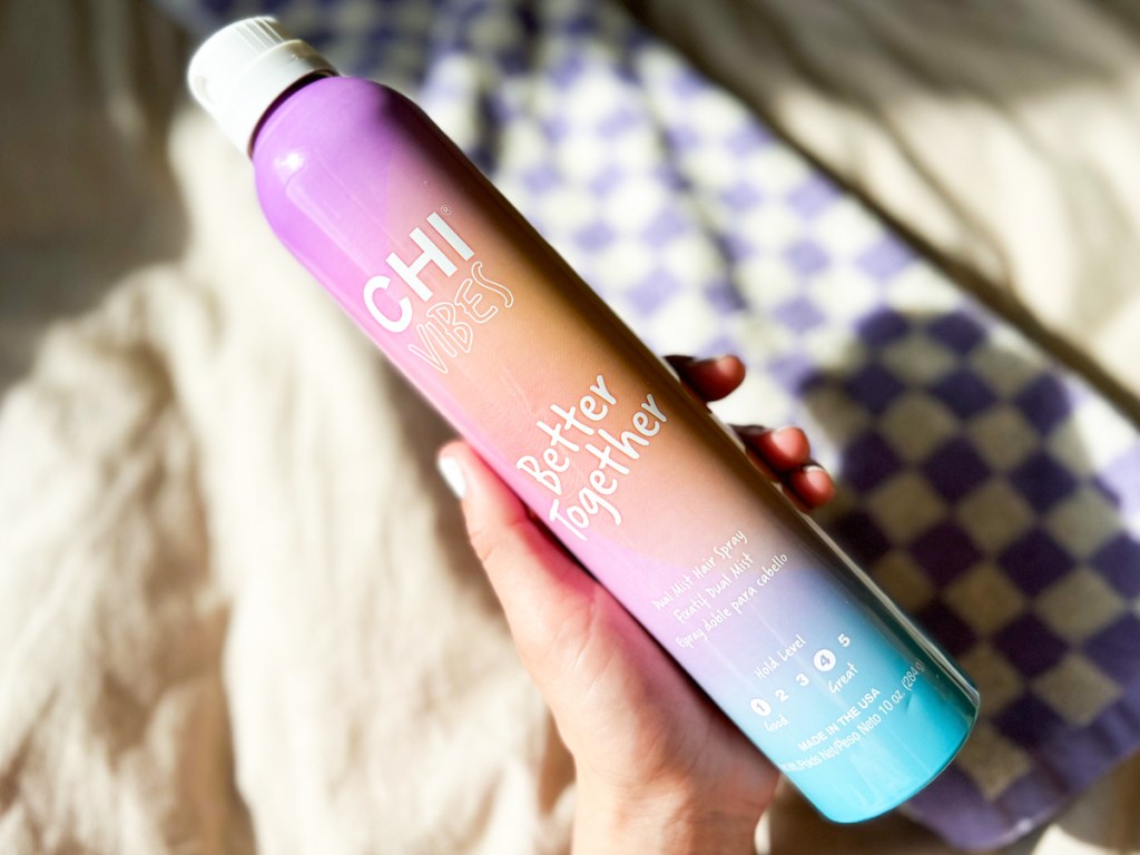 hand holding can of CHI Vibes Better Together Dual Mist Hair Spray