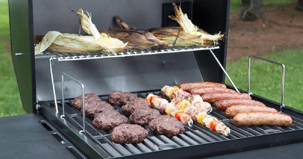 Cart-Style Charcoal Grill w_ hamburgers, hot dogs, corn and skewers cooking