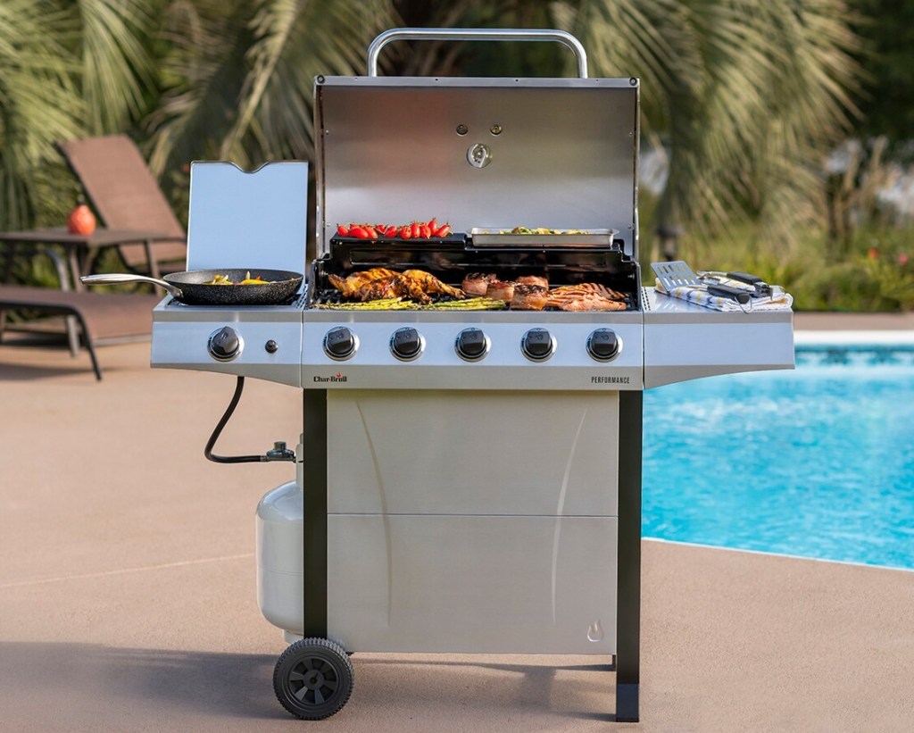 Grill with the lid open and food on it 