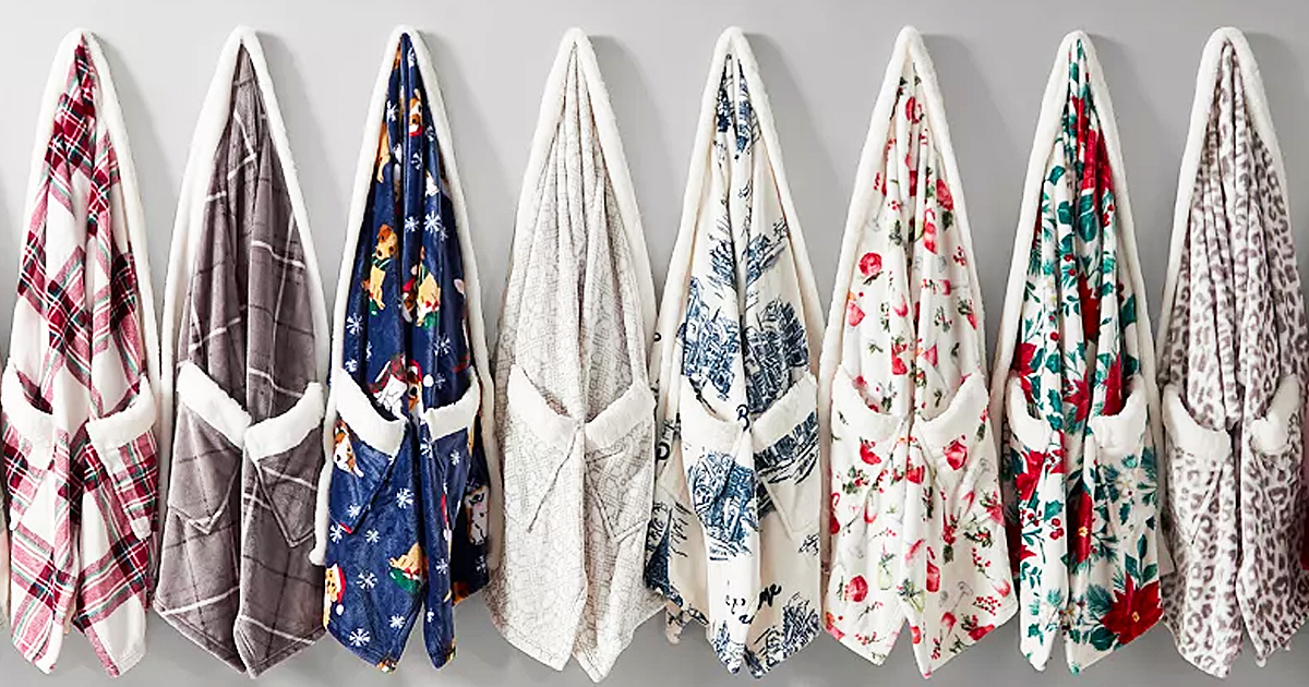 row of wrap blankets hanging on hooks on wall