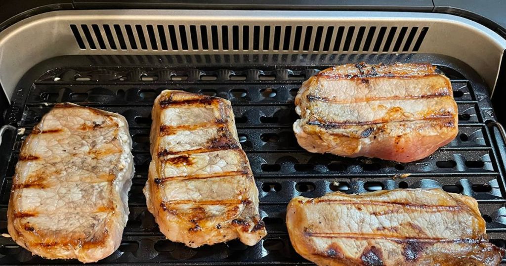 pork chops cooking on indoor grill