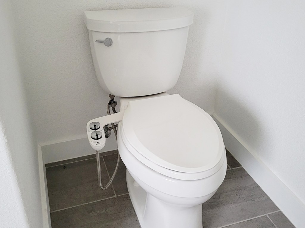 toilet with a bidet attachment installed