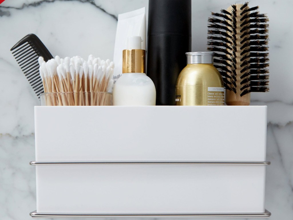 Command Bath Wall and Cabinet Organizer with beauty products in it including hair brush and hair spray
