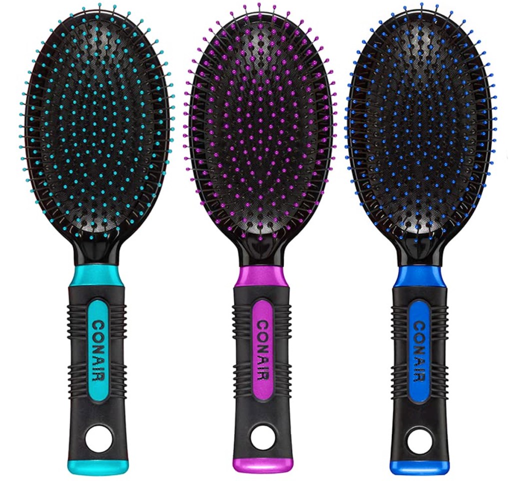 three oval hair brushes