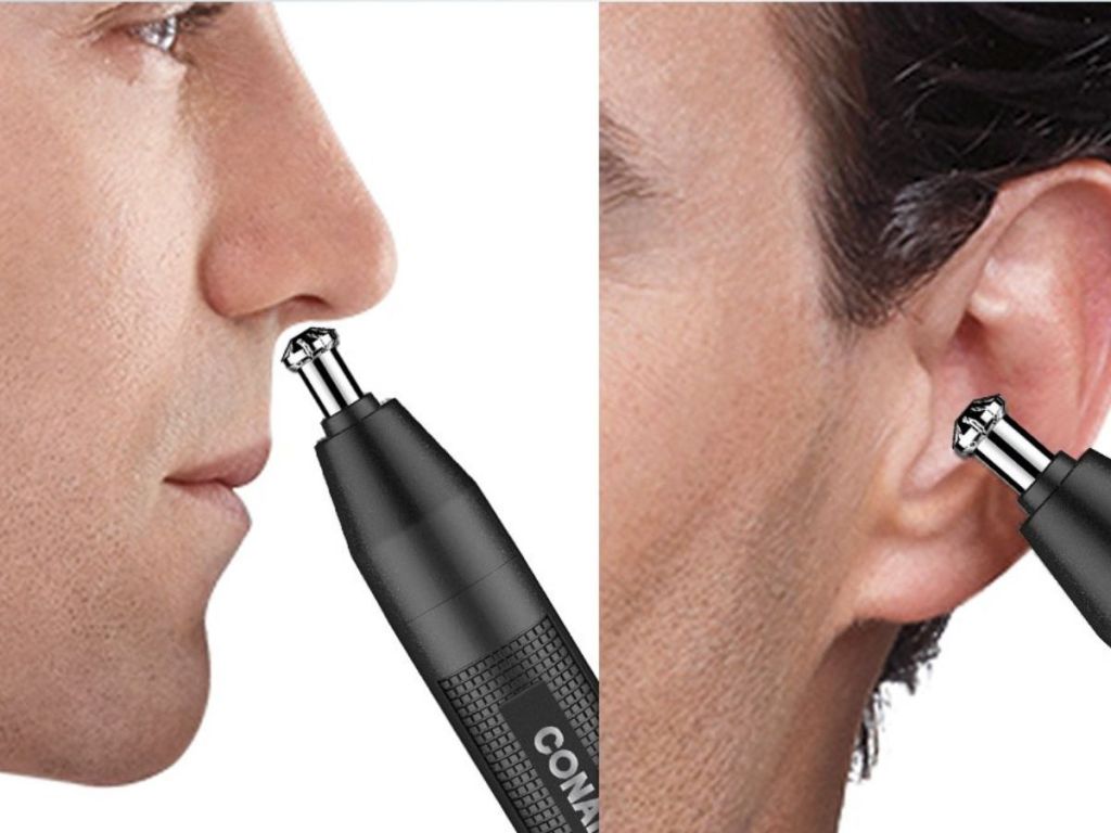 A man trimming his ears and nose with a battery powered trimmer