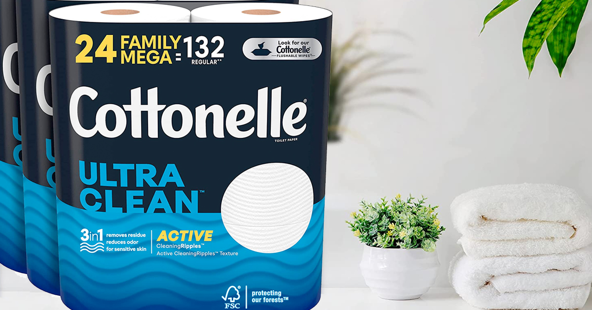 packs of cottonelle toilet paper near folded towels and plant