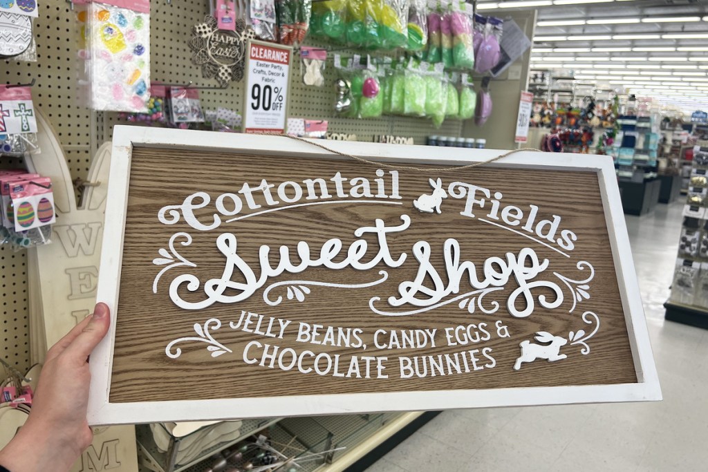 hand holding Cottontail Fields Sweet Shop Sign