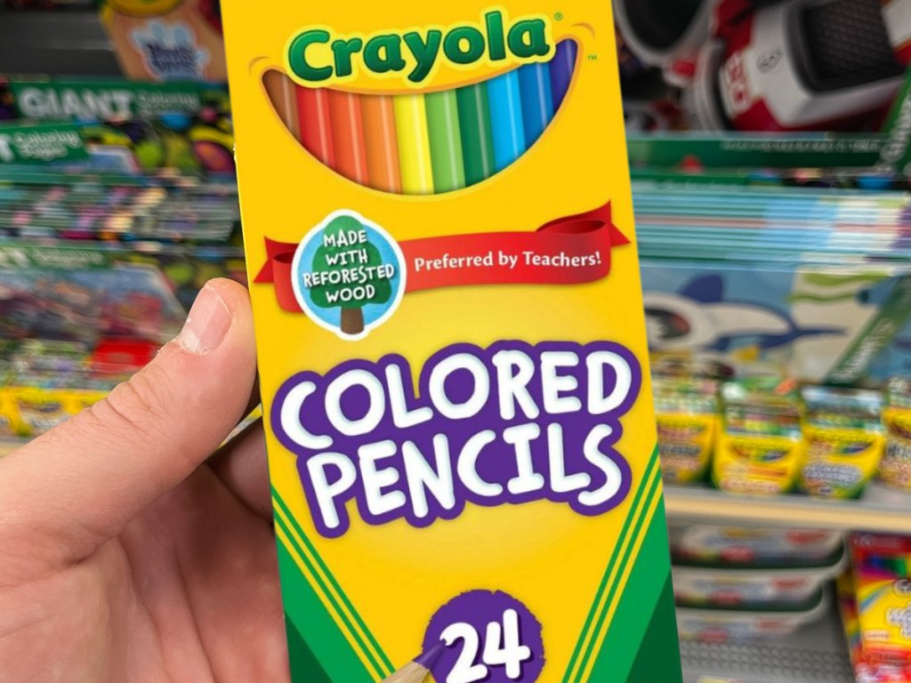 hand holding a box of 24 Crayola colored pencils