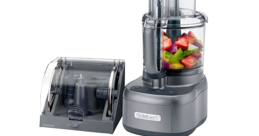 Cuisinart food processor filled with fruit next to the atachment case