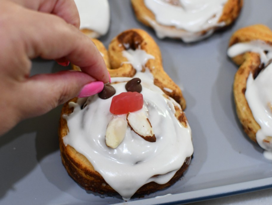Decorating a cinnamon roll bunny for Easter brunch