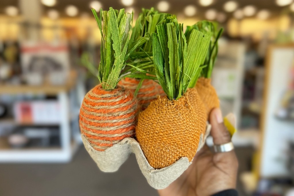 hand holding up a set of carrot easter eggs